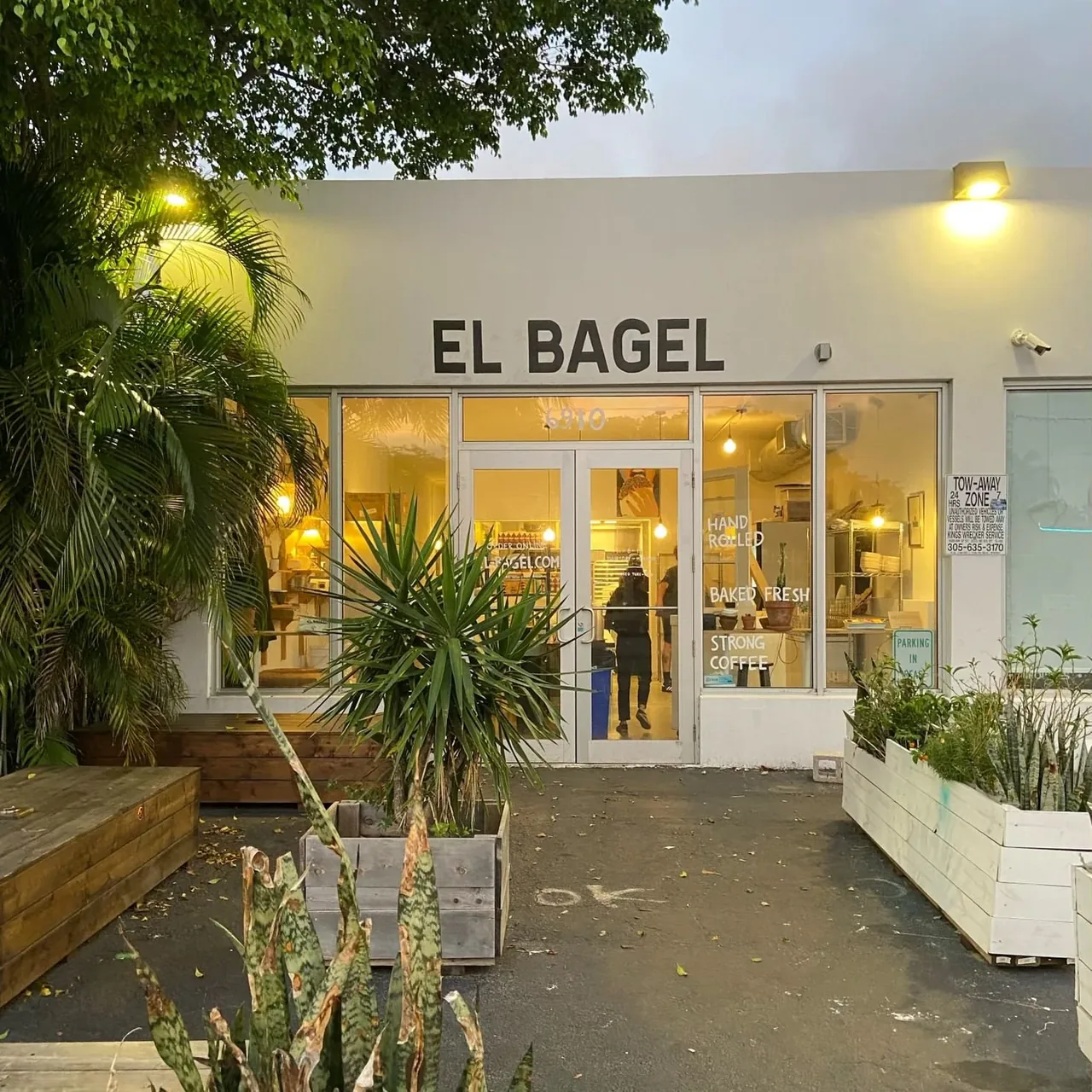 El Bagel storefront at dusk