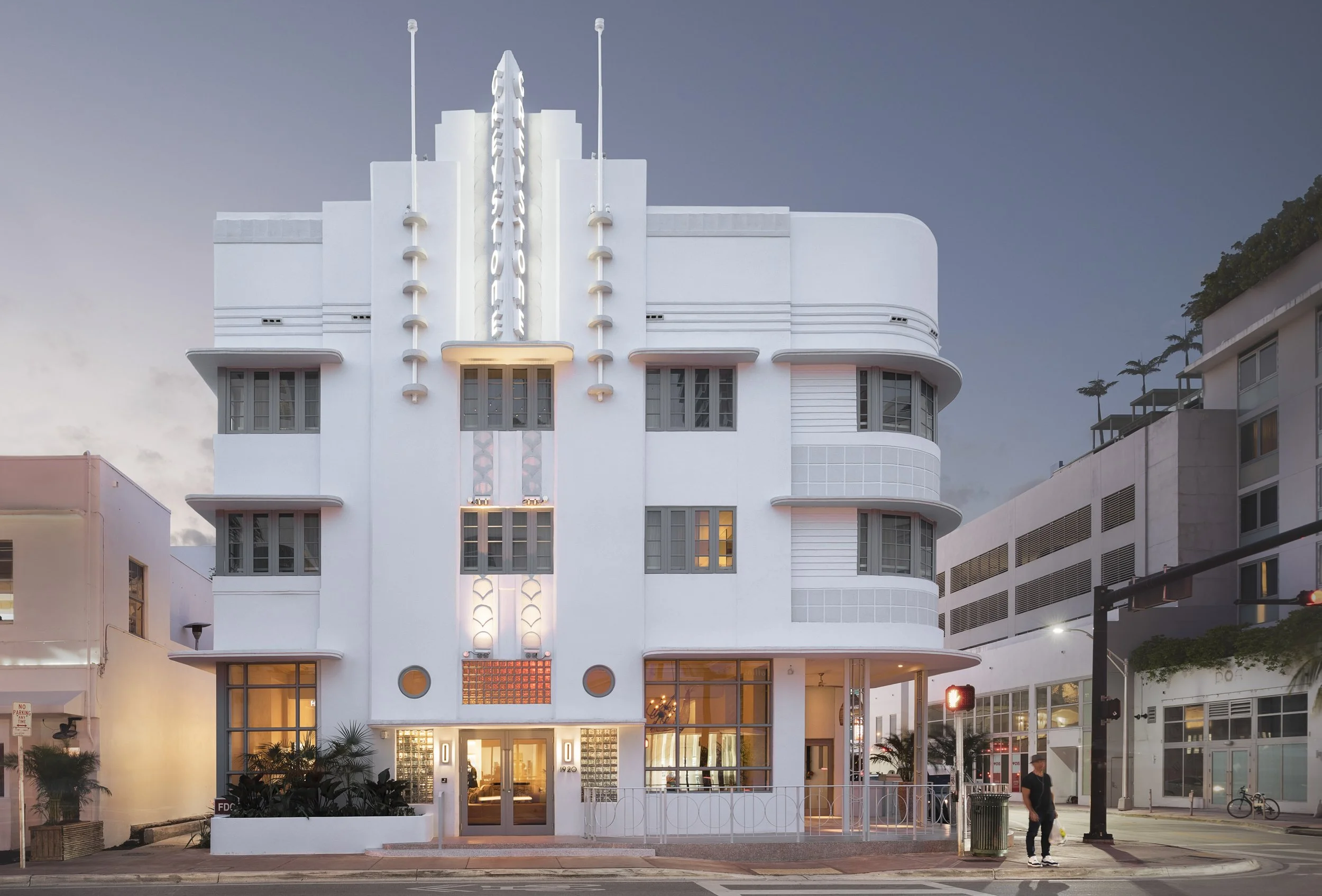The restored Art Deco facade of Hotel Greystone on Collins Avenue at dusk