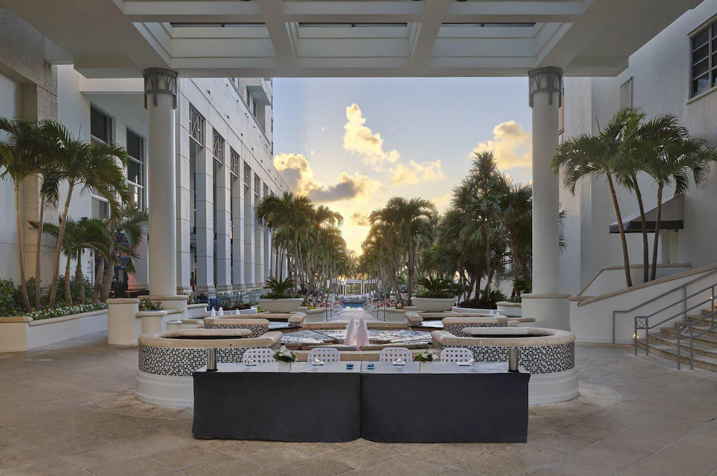 Palm-lined courtyard and fountain at the Loews Miami Beach Hotel